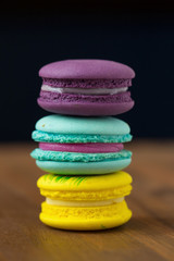 Tasty macaroons with almond on wooden background