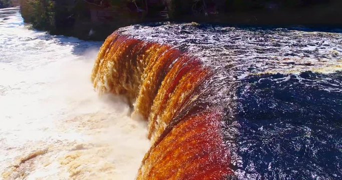 Springtime waterfall raging in Upper Michigan, this is upper Tahquamenon Falls, aerial view.
