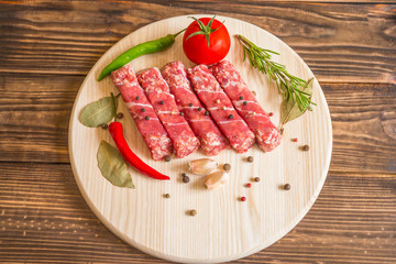 Raw cevapcici dish of mixed meats, the food of the Balkans. Minced meat and bacon.