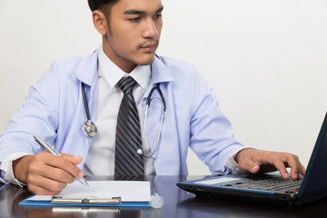 doctor writing RX prescription in medical office clinic on desk, stethoscope with clipboard