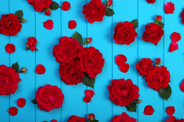 Red roses flowers on blue wood.