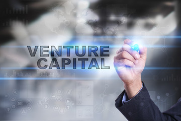 Fototapeta na wymiar Businessman is drawing on virtual screen. venture capital concept.