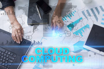 Woman working with documents, tablet pc and notebook and selecting cloud computing.