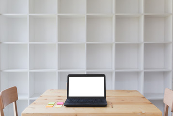 Working at desk with sticky note, pencil and laptop computer