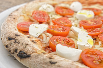 Pizza with fresh tomatoes and mozzarella closeup