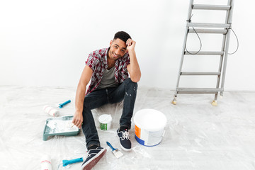 Full-length shot of man during repair between equipment