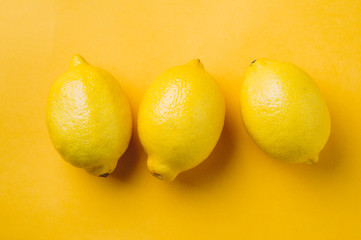 Lemons on yellow background