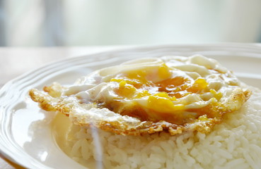 fried egg dressing soy sauce topping on rice