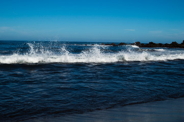 Splash wave and black sand beach. Atlantic Ocean, island of Tenerife, Spain