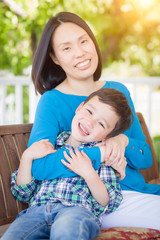 Fototapeta premium Outdoor Portrait of Chinese Mother with Her Mixed Race Chinese and Caucasian Young Boy