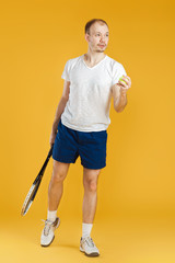 Fototapeta na wymiar young tennis player plays tennis on yellow background