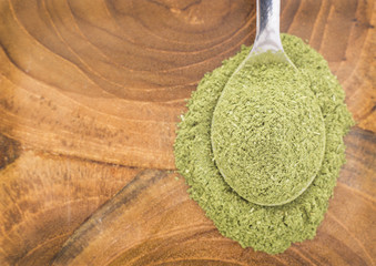 Moringa powder on the wooden background - Moringa oleifera