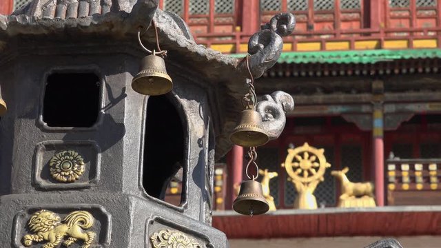 Facade details decoration bell Gandantegchinlen Chinese-style Tibetan Buddhist Monastery. Center of Mongolian capital of Ulaanbaatar. Religion world famous attraction. Colorful sunny day