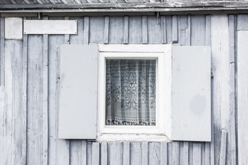 Obraz na płótnie Canvas Wooden cottage gray wall with window.