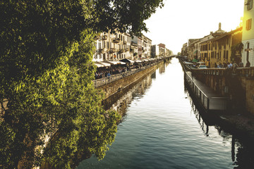 The Naviglio Grande canal waterway in Milan, Italy, at sunset. This district is famous for its...