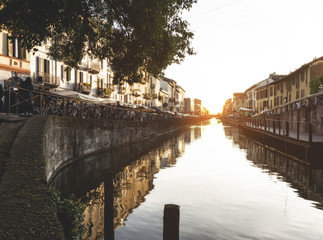 The Naviglio Grande canal waterway in Milan, Italy, at sunset. This district is famous for its...