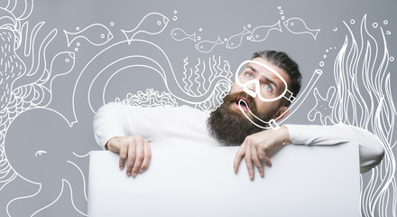 bearded surprised man hipster with painted diver mask and underwater