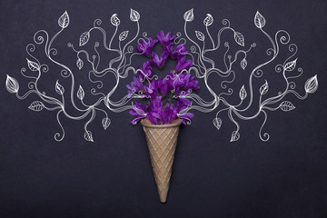 wafer or waffle ice cream cone and violet spring flowers