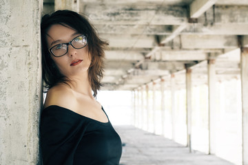 Fototapeta premium Young woman on background of the destroyed architecture.