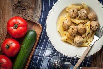 Pork meatballs with dill sauce and pasta. Selective focus.