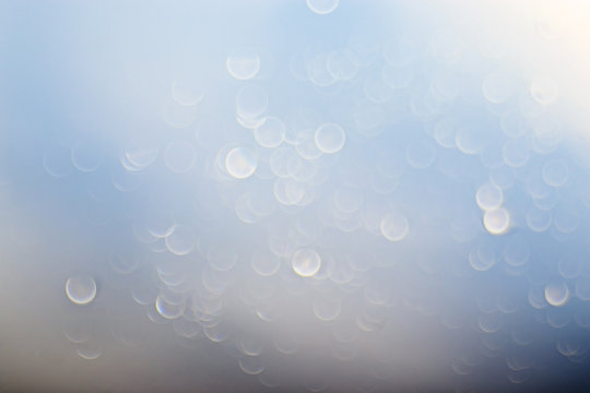 light blue background bokeh drops glass, blurred