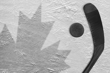 Naklejka premium The image of the Canadian flag and hockey puck with the stick