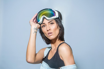 pretty woman in ski goggles or safety glasses