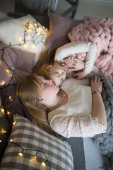 Beautiful young mom and daughter sleep embracing