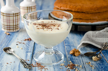 Yogurt cream for cake with chocolate and nut crumbs.