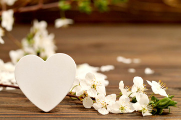 Mothers Day card with heart shape decoration and spring flowers. Love concept