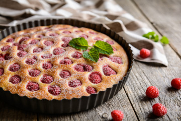 Juicy raspberry pie with powdered sugar icing