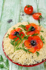 Salad decorated with poppies made of sliced tomatoes and olives