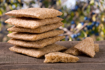 stack of crisp bread on a wooden table isolated white background