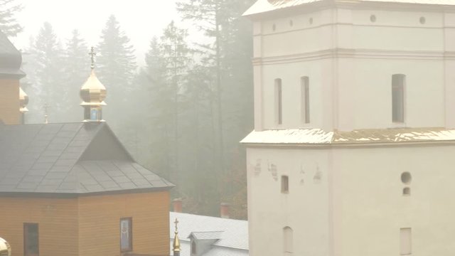 Buildings of Orthodox Male Cloister Misty Day Manyava Skete Ancient Architecture Museum Among Picturesque Coniferous Boreal Forest Trees on a Background