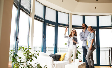 Female Real Estate agent offer home ownership to young couple.