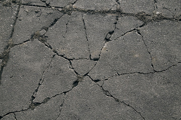 Obraz premium Asphalt with cracks. cracked asphalt road surface texture. 
