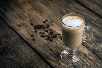 Coffee cup and coffee beans on table