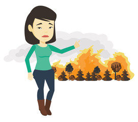 Woman standing on the background of wildfire.
