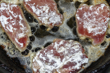 The meat is fried in a frying pan