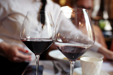 Serving a glass of red wine in a restaurant