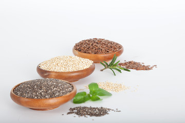 Healthy grains in wooden bowls. Chia, quinoa and flax seed. Vegan food.