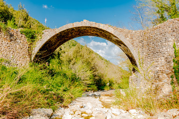 medieval stone bridge in the Tuscan woods