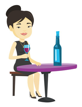 Woman drinking wine at restaurant.