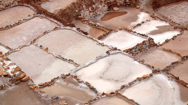 SALT MINING: video footage from Maras, Peru. Region of Cusco in andean landscape in South America, Peru.