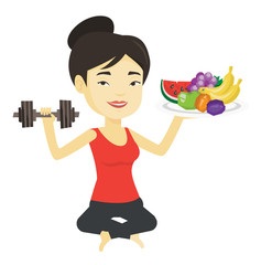 Healthy woman with fruits and dumbbell.