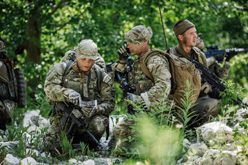 Special forces soldiers with weapon take part in military maneuver. war, army, technology and people concept.