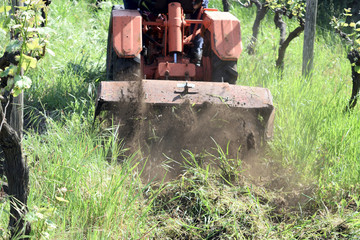 Naklejka premium plowing of the soil with old rotary hoe