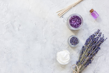 Fototapeta na wymiar lavender flowers in organic cosmetic set on stone background top view mock-up