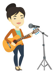 Obraz premium Woman singing in microphone and playing guitar.
