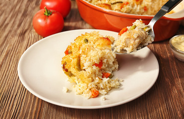 Tasty rice with chicken and vegetables on plate